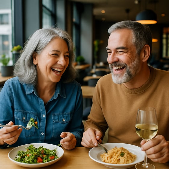 A middle age 50 to 60 years old couple enjoying a meal in a modern restaurant Its evident they are retired and yet their energy and cheerfulness is ev-1